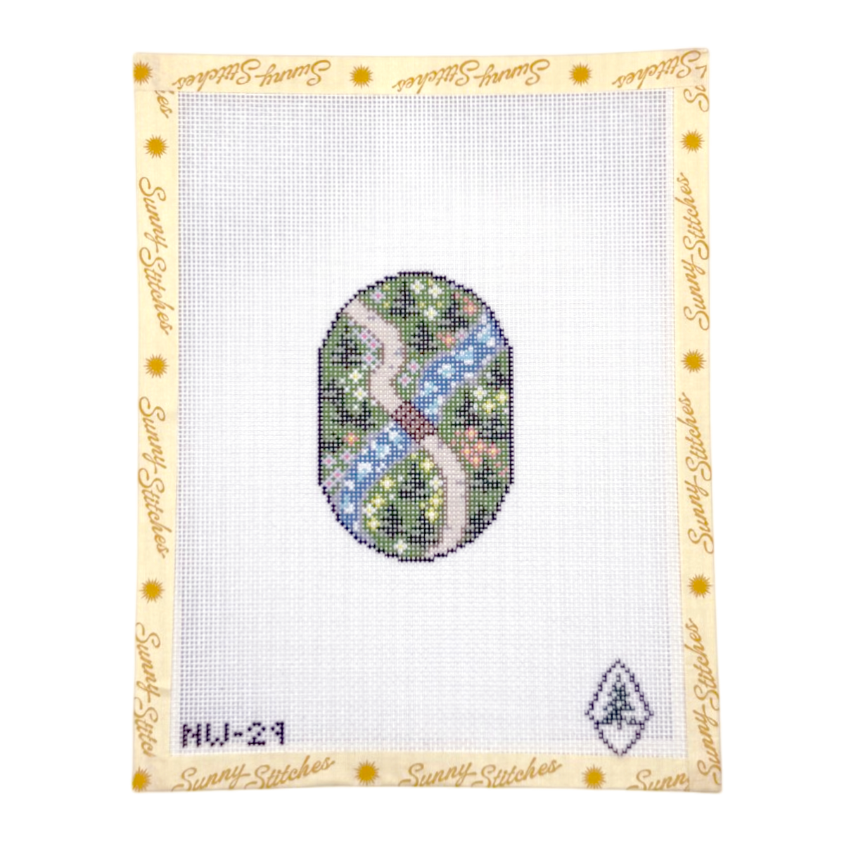 A needlepoint canvas from Sunny Stitches, featuring a central oval design with an arial view of a winding pink path through green, blue, and white foliage, surrounded by a cream border printed with the brand name 'Sunlit Stitches'.