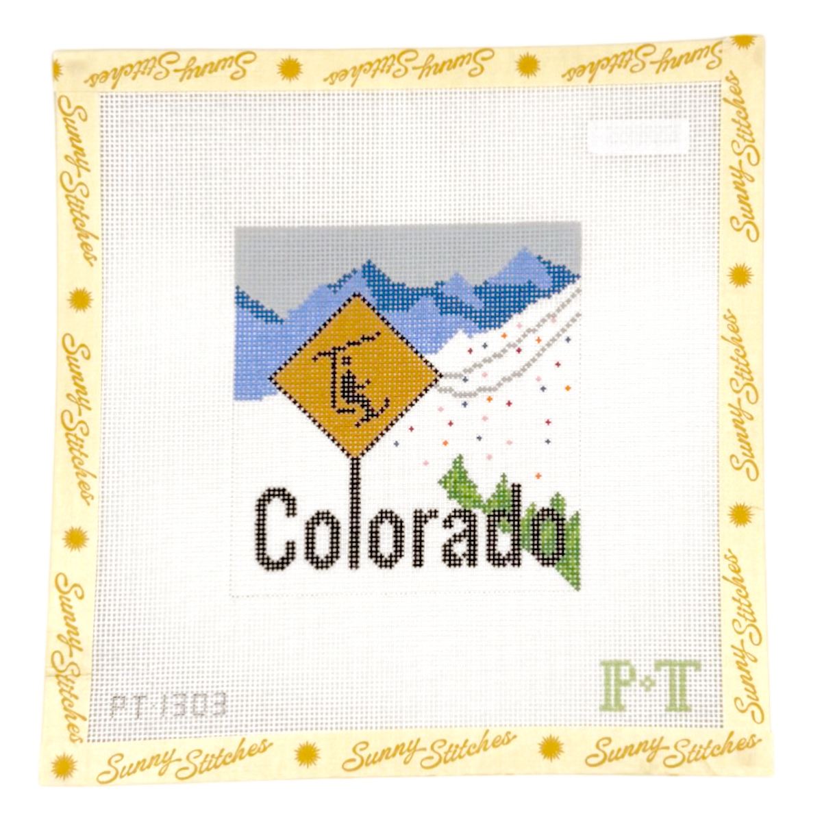 A square cross-stitch pattern from Sunny Stitches featuring a Colorado mountain design with a ski sign. The design includes a yellow diamond-shaped road sign with a horse, blue and gray mountains, green pine trees, and the word 'Colorado' stitched below.