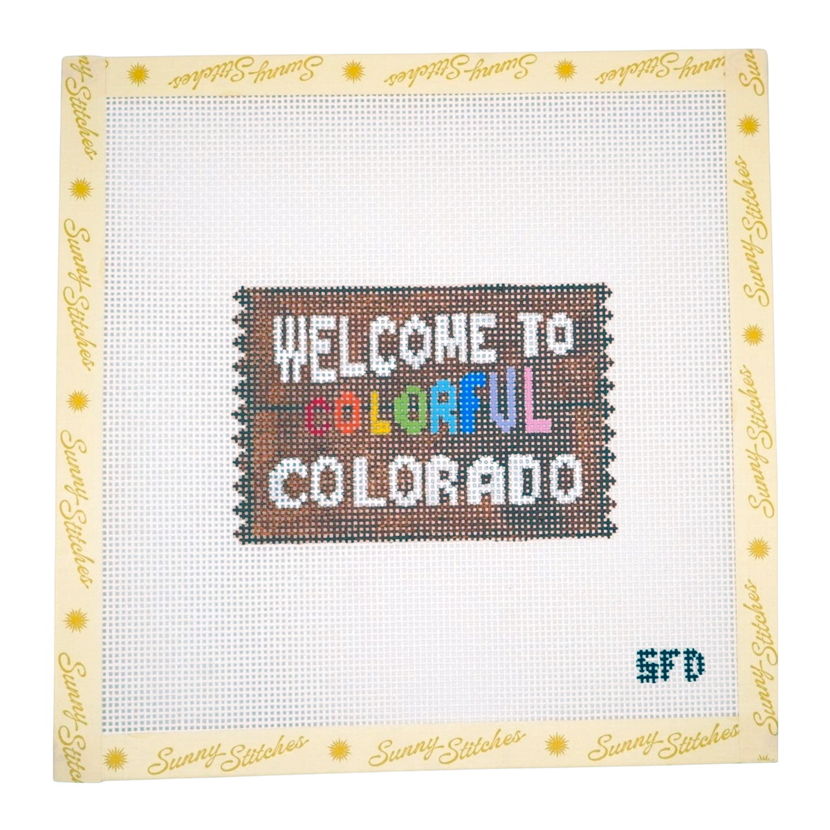 Sunny Stitches cross-stitch canvas featuring the text 'WELCOME TO COLORFUL COLORADO' stitched in multicolor on a white grid background, surrounded by a cream border printed with the Sunny Stitches brand name.