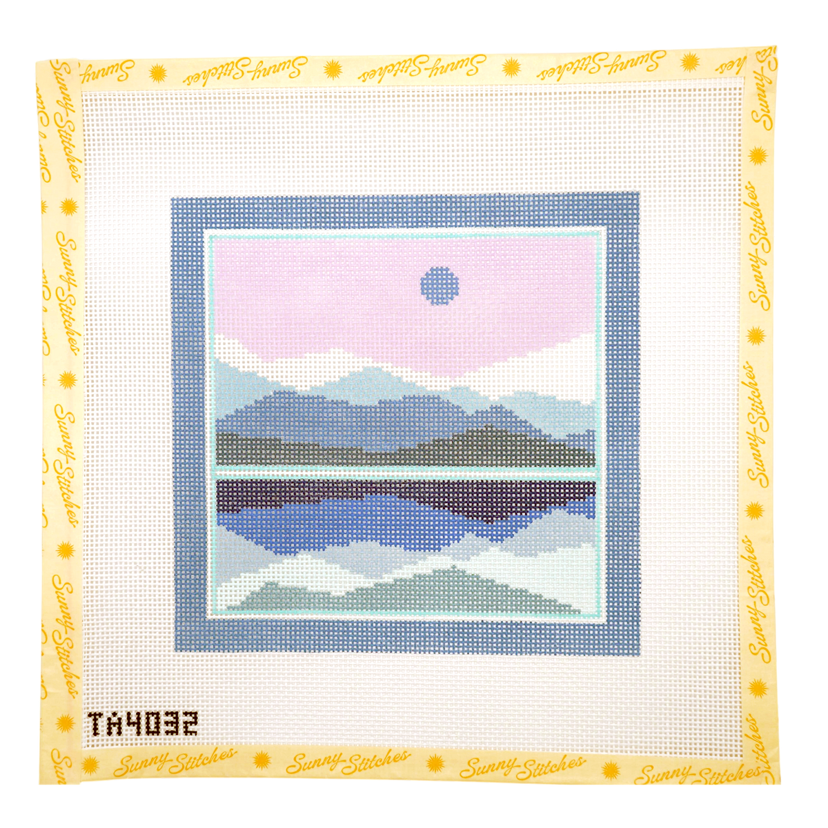 A square needlepoint canvas from Sunny Stitches, featuring a mountain and lake landscape design. The central design has a pink sky, blue mountains, and a blue lake reflection, surrounded by a light blue border on a white grid canvas with a yellow printed border.